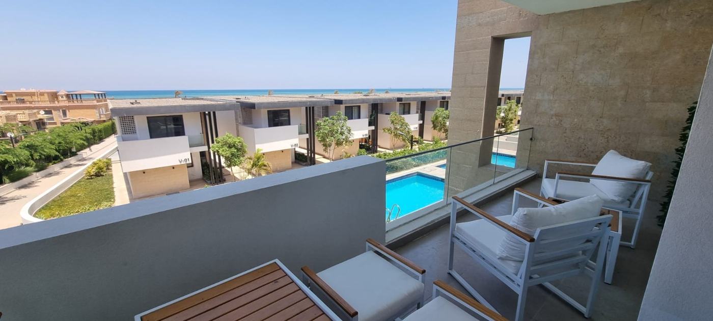 Terrace of a Kai Sokhna chalet looking over the pool towards the Red Sea